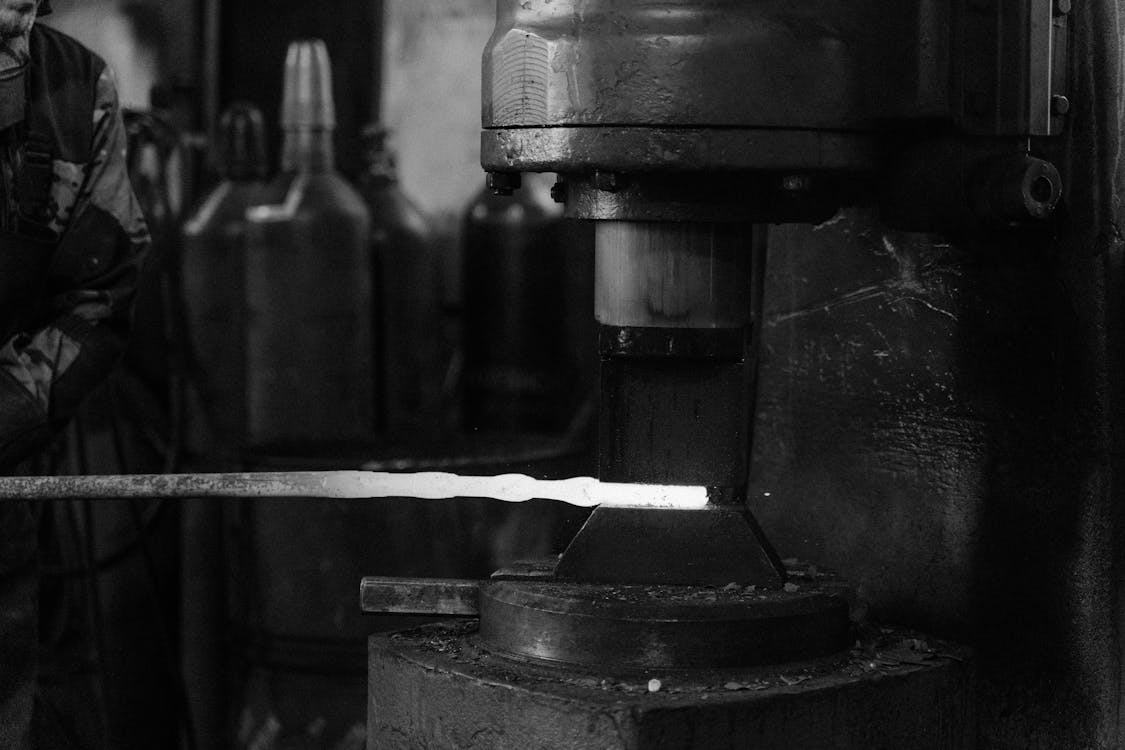 Grayscale Photo of Metal Forging