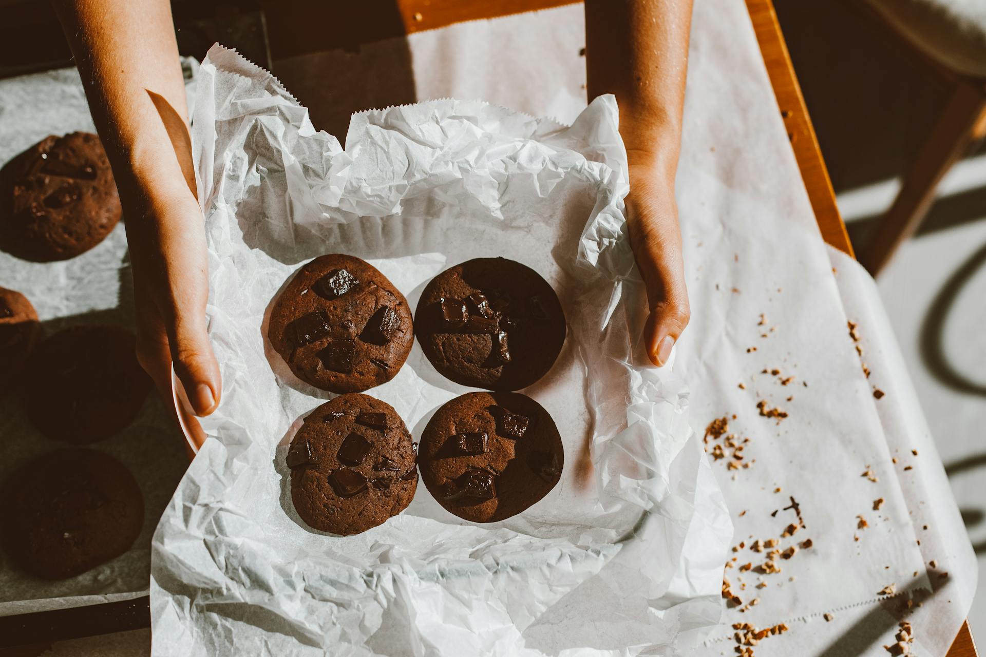 Hands Holding Chocolate Cookies