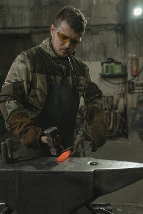 Blacksmith hammering a Hot Piece of Metal 
