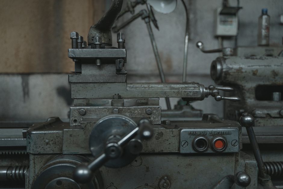 Close-up of an antique lathe showcasing tools and machinery in a vintage workshop.