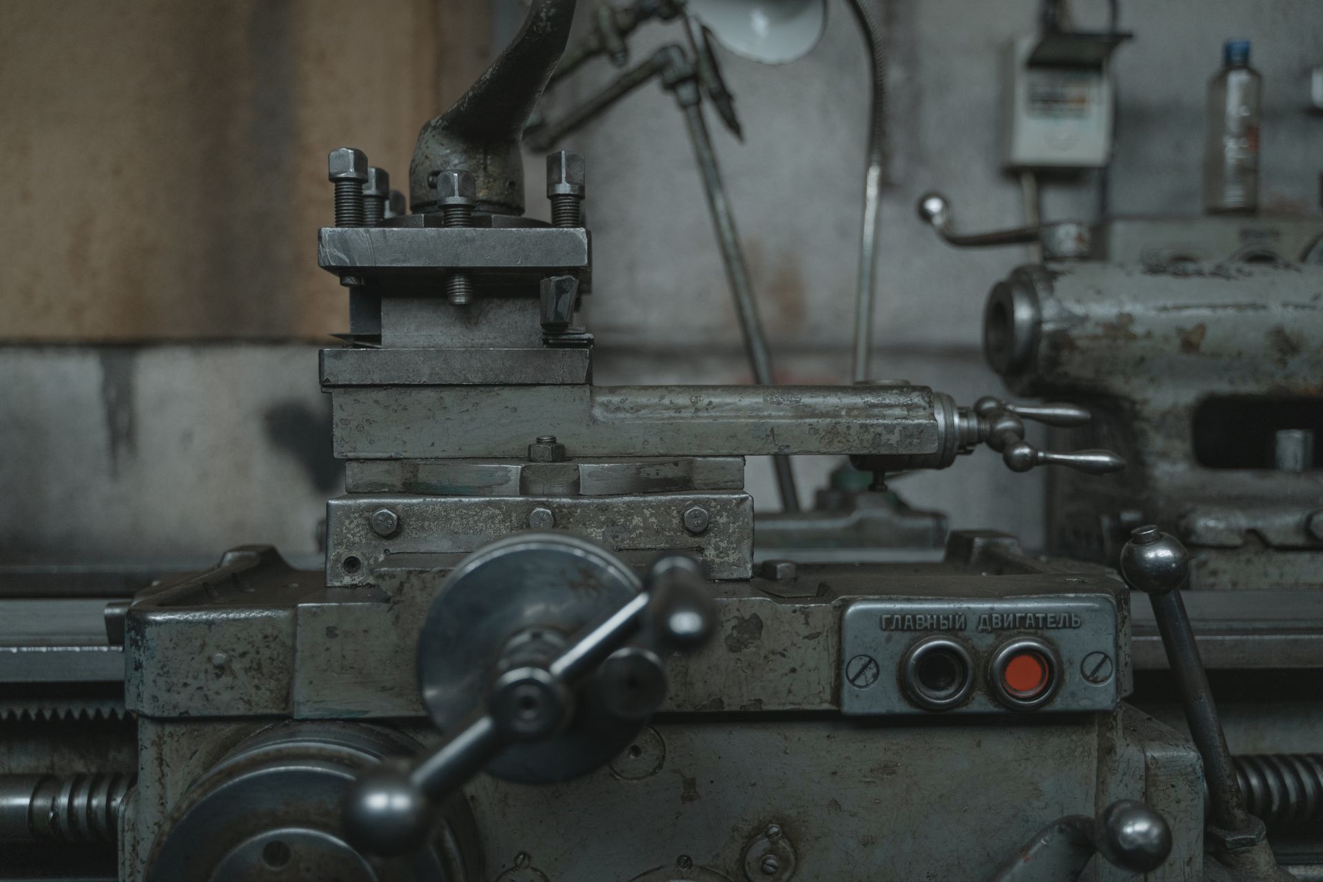 Close-up of an antique lathe showcasing tools and machinery in a vintage workshop.