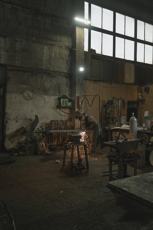 Man Welding a Metal in a Workshop