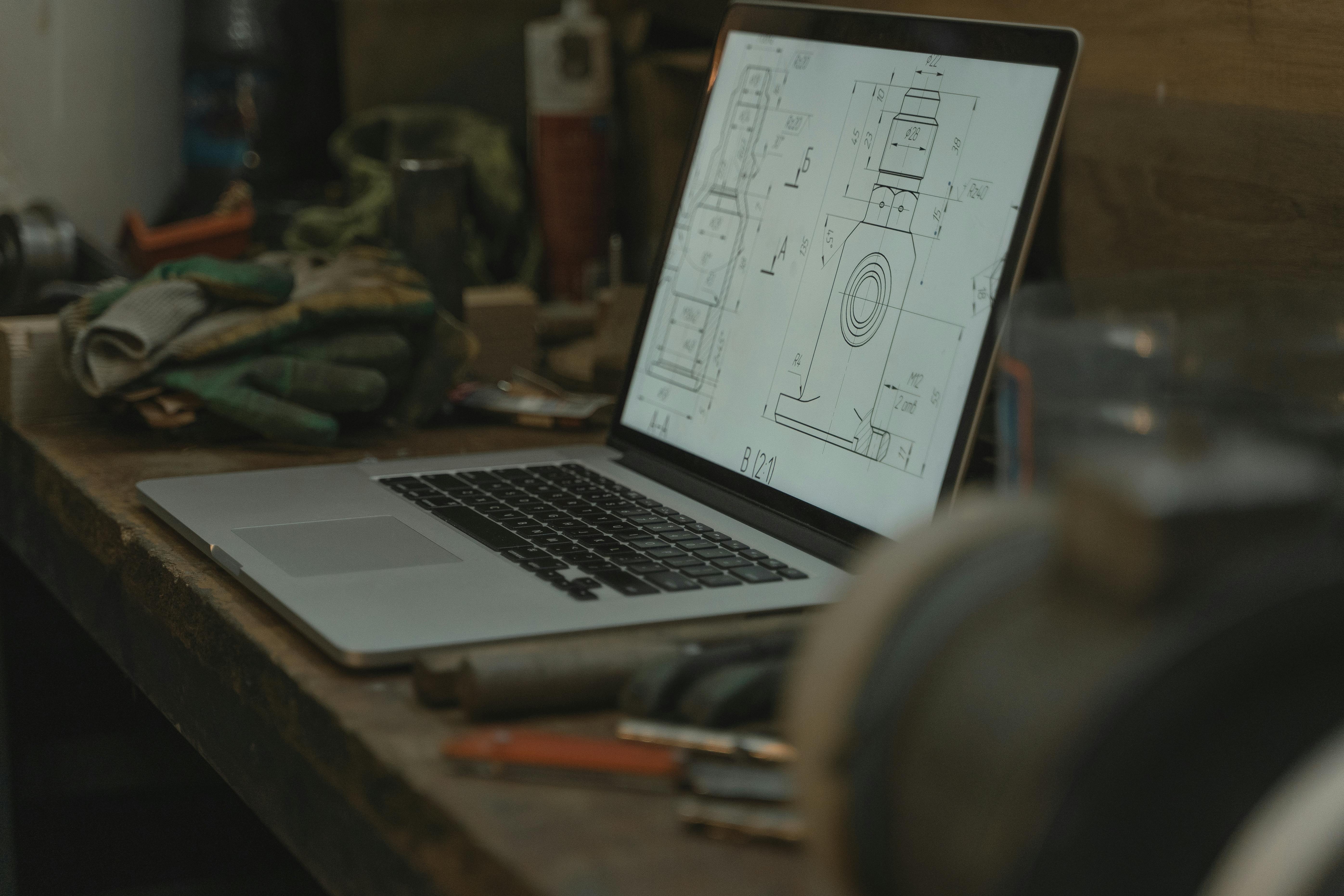 macbook pro on brown wooden table