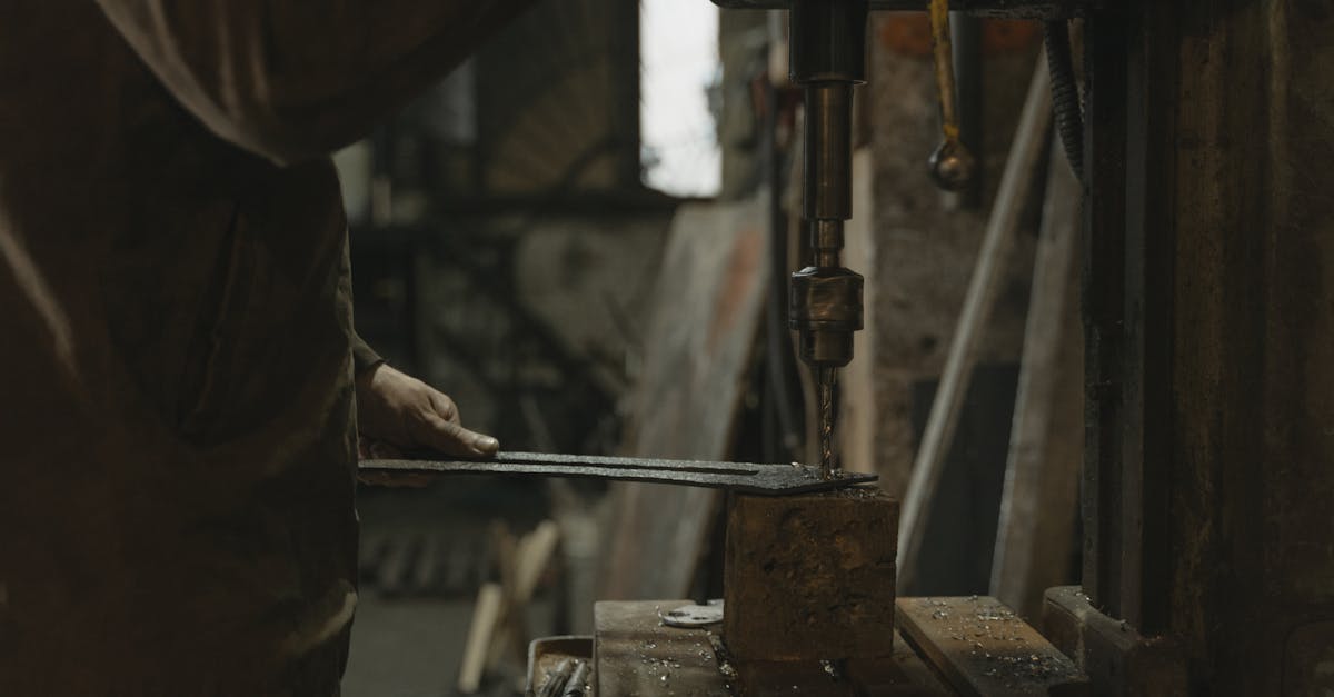 Man in Brown Jacket Holding Black Metal Tool
