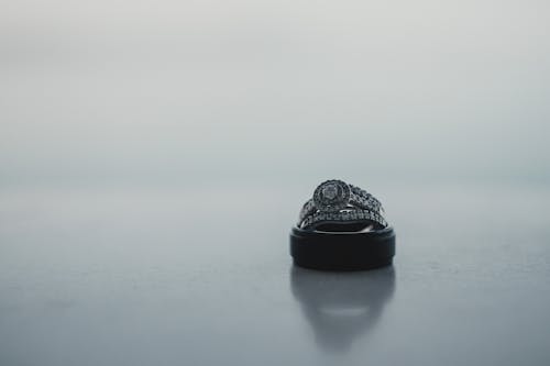 Engagement rings on straight white surface