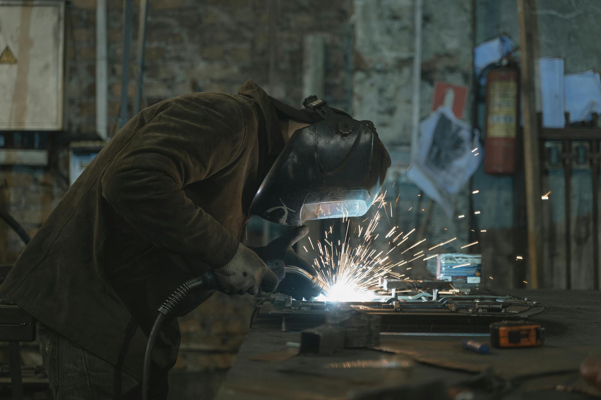 A Person Welding at a Workshop