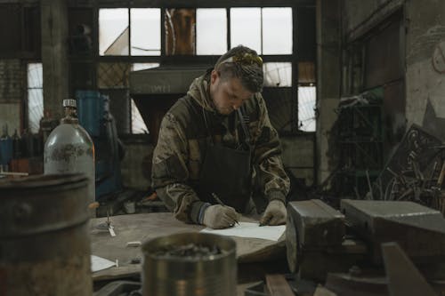 A Man Writing on White Paper