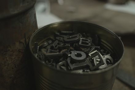 Loose metal letter sorts in a workshop pail — photo by Tima Miroshnichenko on Pexels