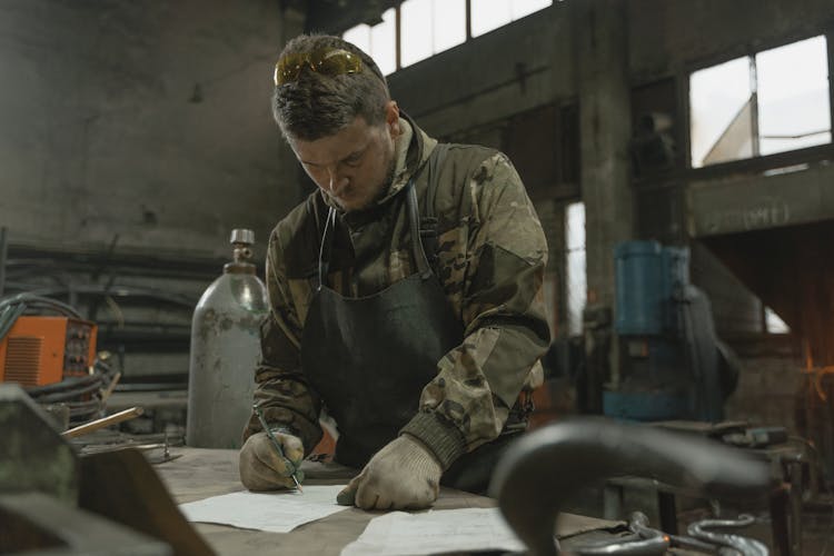 A Man Drawing On The Paper 