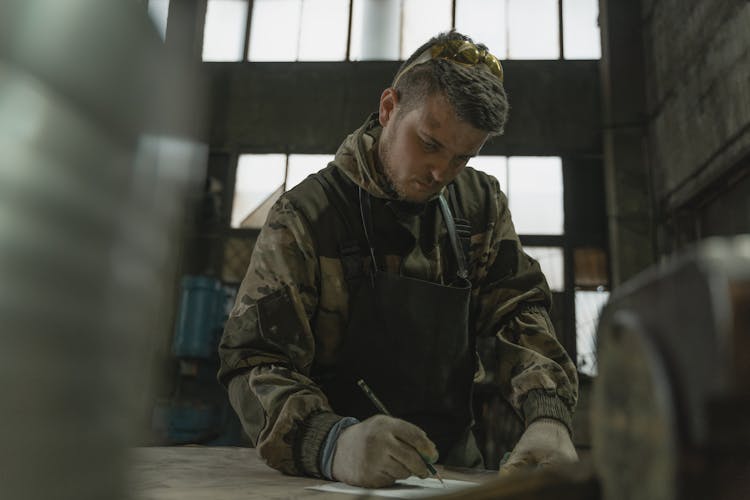 A Man Drawing On The Paper 