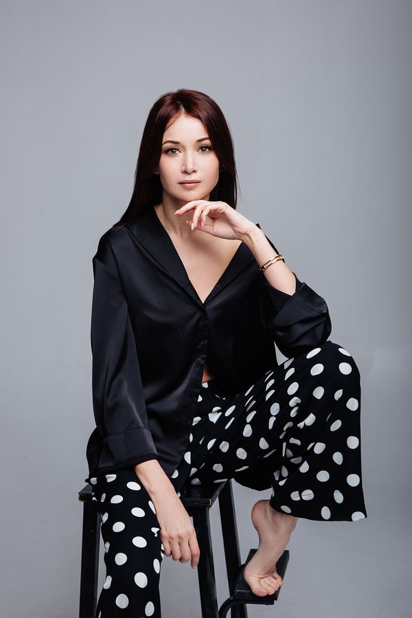 Woman in black satin shirt elegant evening work outfit