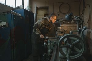 An engineer at a production machine. Photo by Tima Miroshnichenko on Pexels
