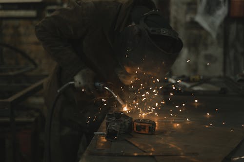 Person in Safety Jacket Holding Welding Machine