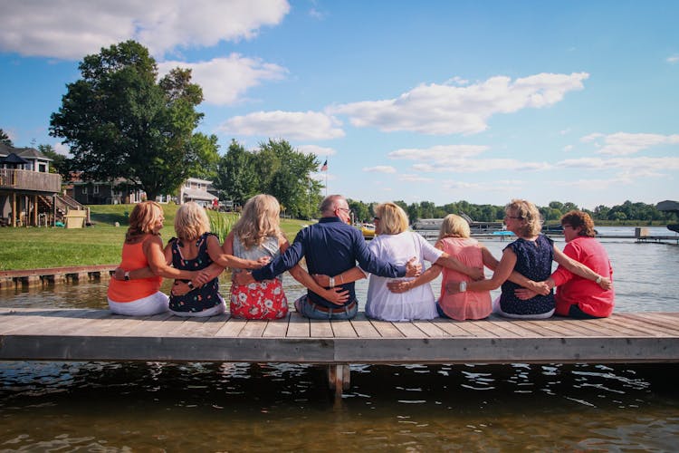 Group Of Elderly Friends On Wooden Pier