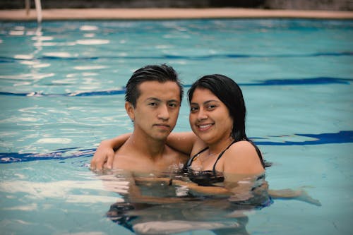 Free A Couple Swimming in the Pool Stock Photo