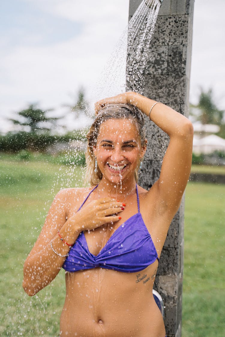 A Woman In A Bikini Showering 