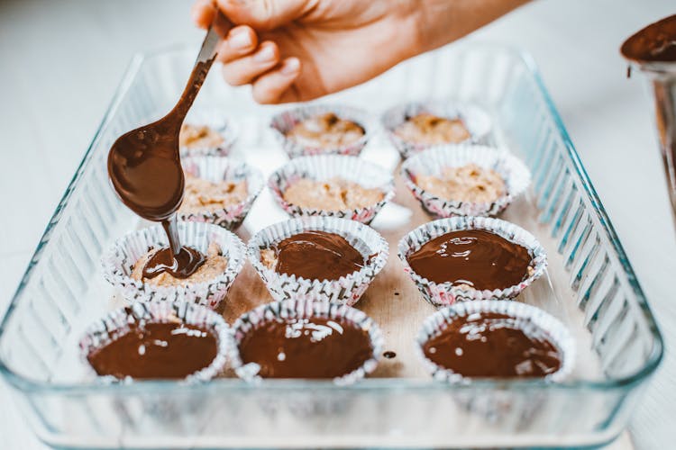 Hand Decorating Cupcakes With Chocolate Icing