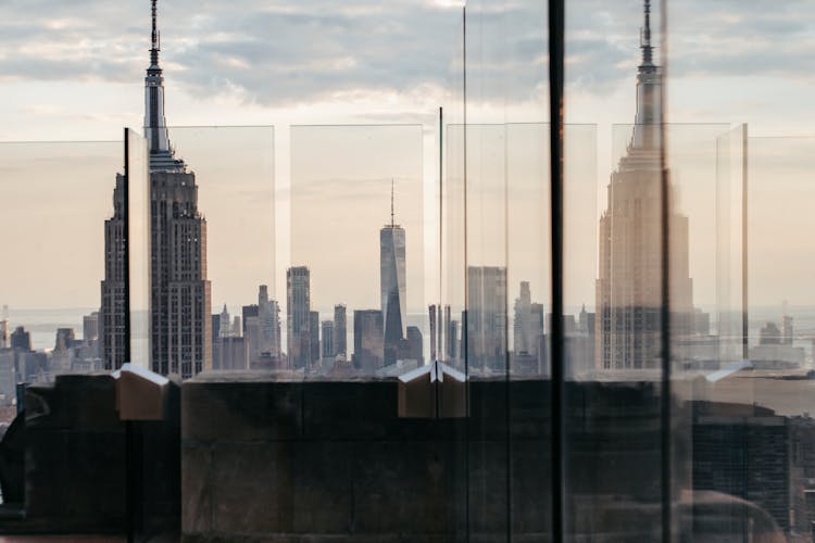 Empire State Building Reflecting In Wall In USA