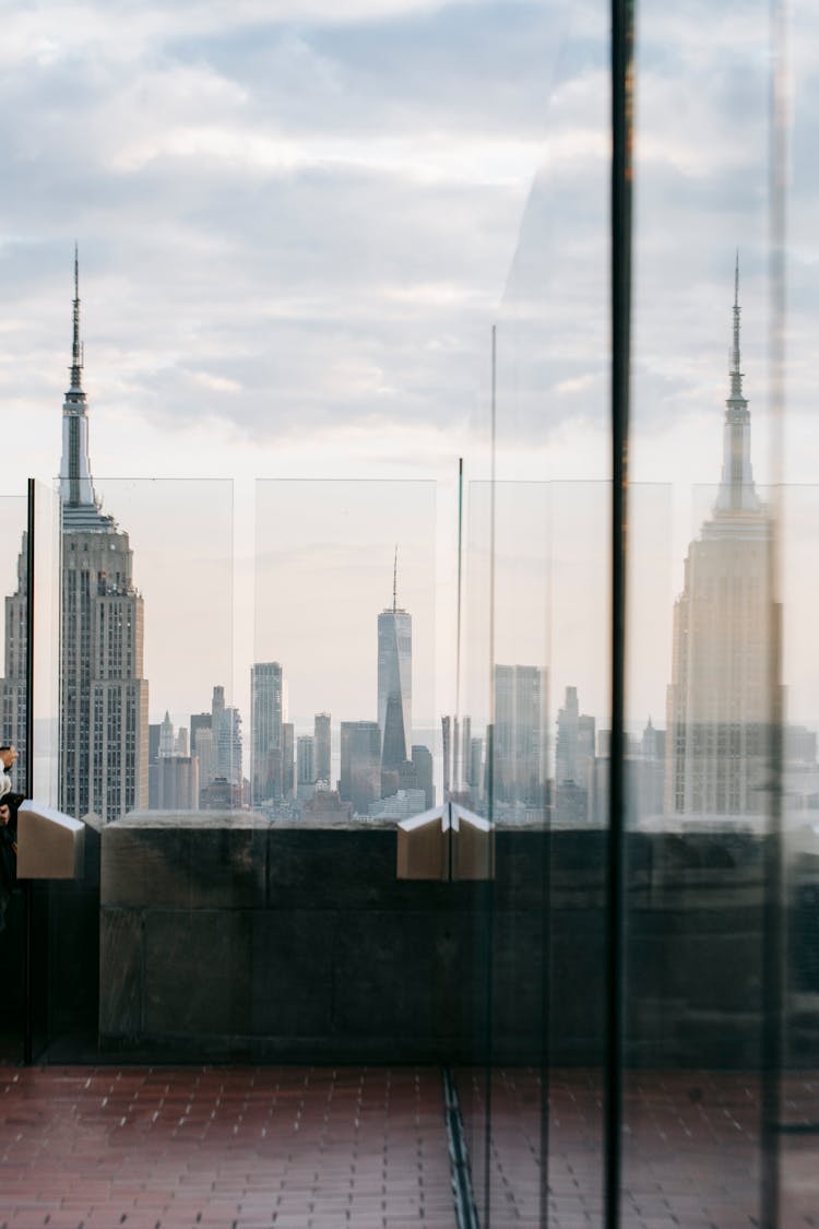 Building Rooftop With Fence Reflecting Skyscraper In USA