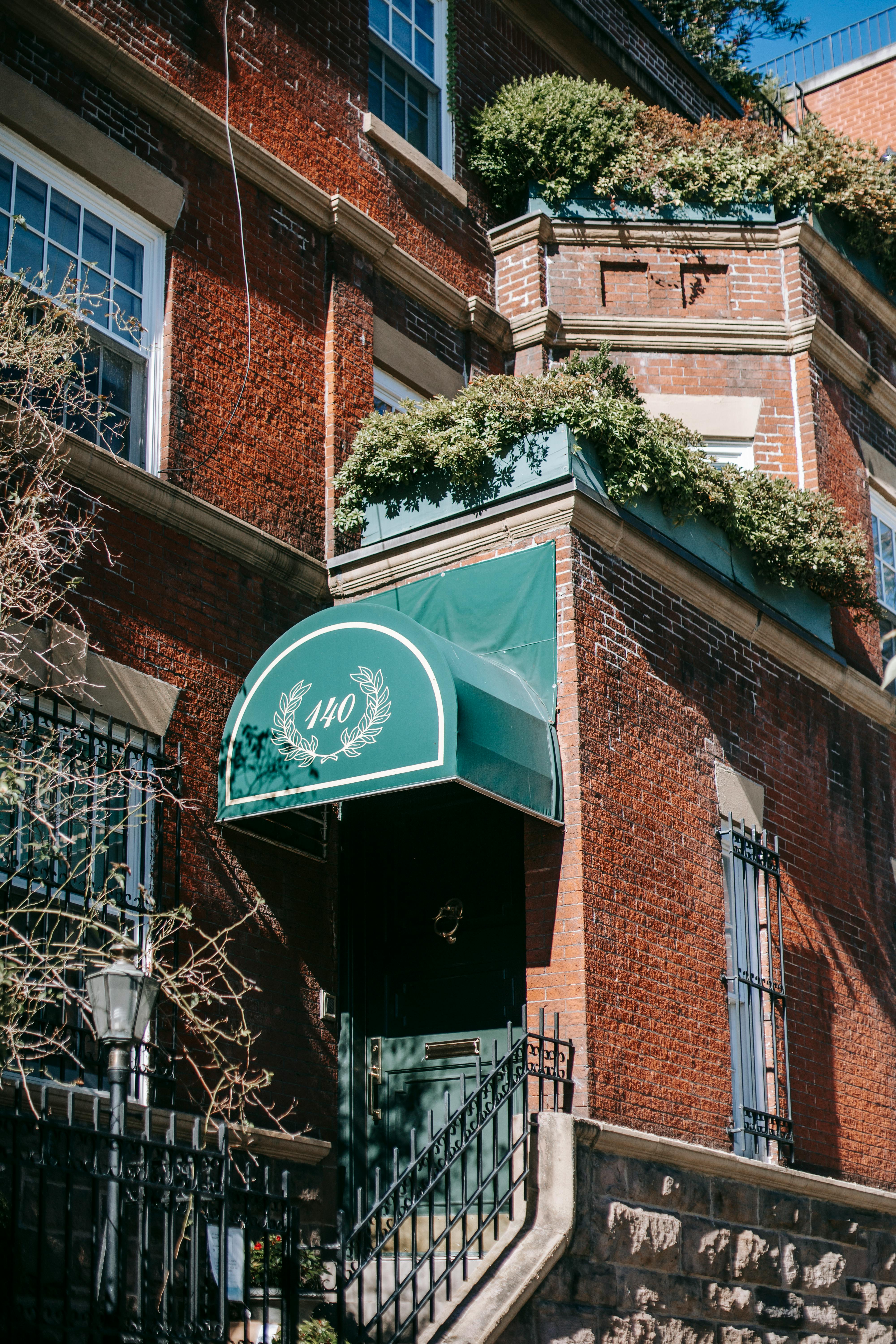 corner of stylish old brick residential building on sunny day