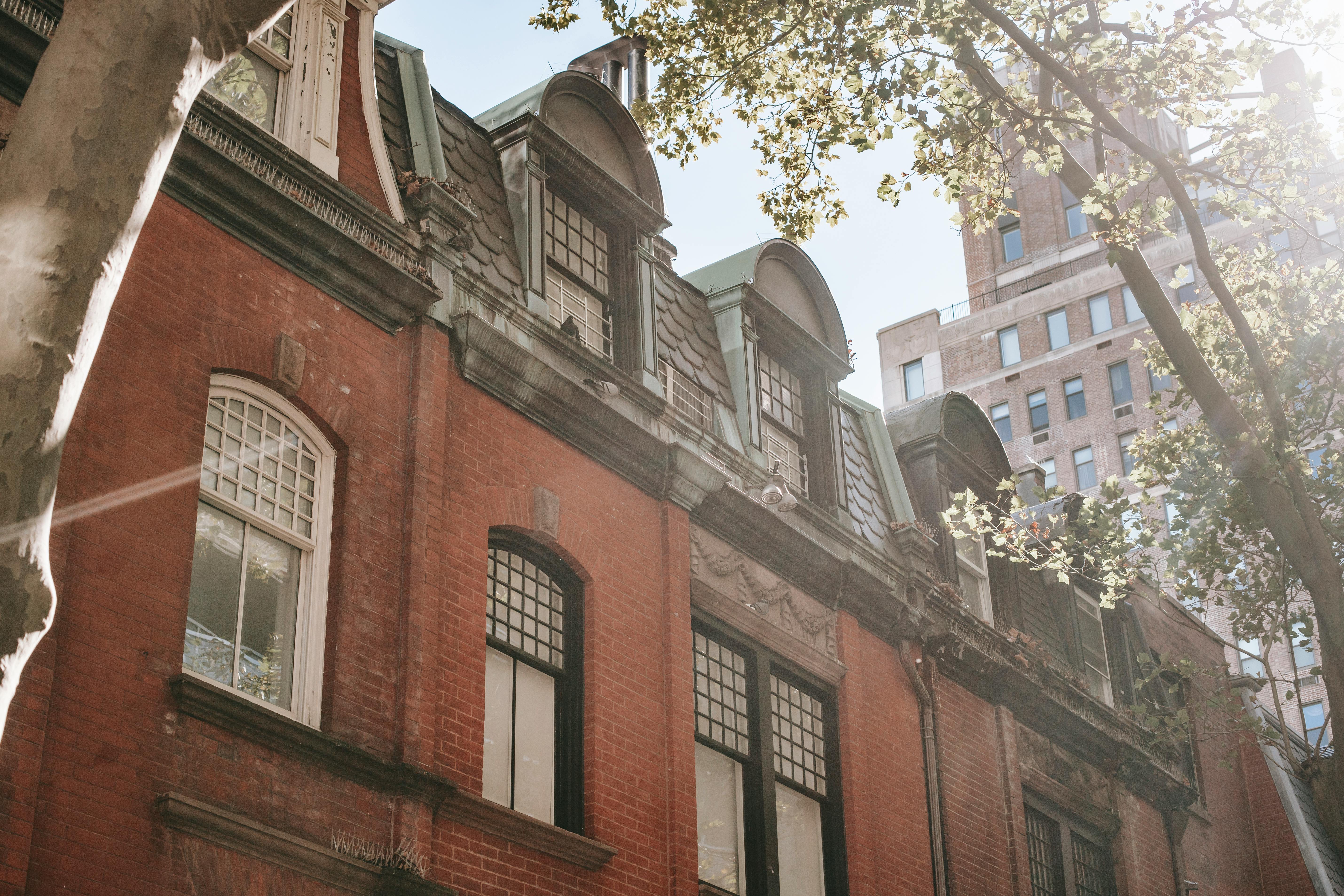 facade of old residential building with brick wall on sunny day