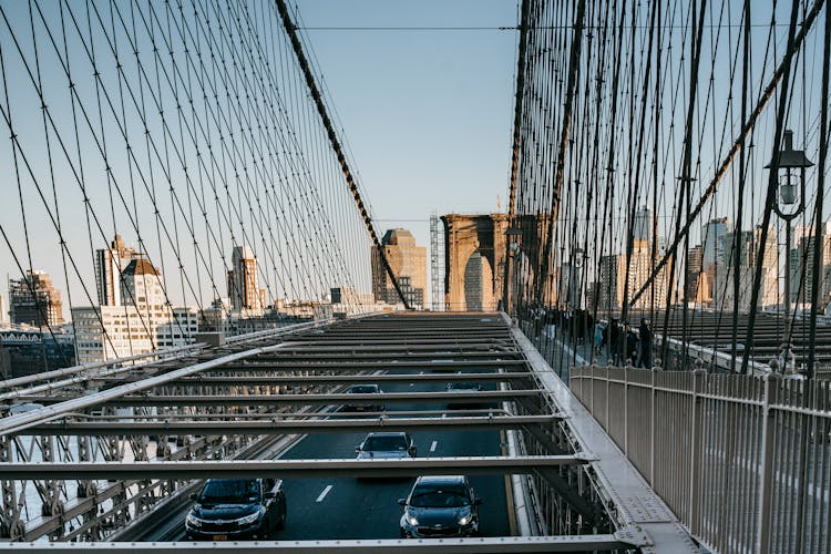 Metal Suspension Bridge With Traffic In City
