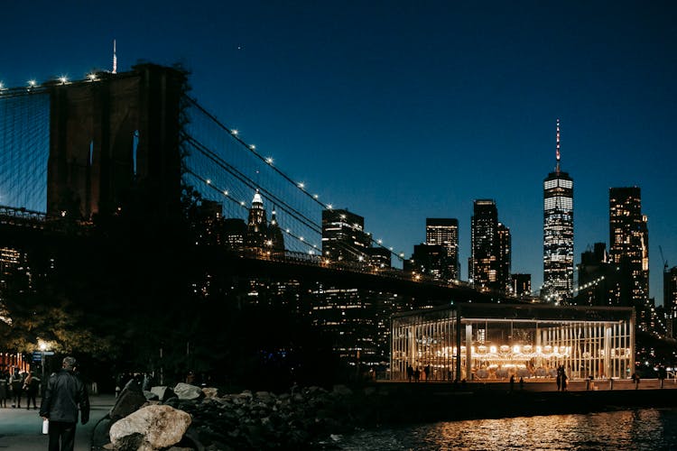 Skyscrapers Behind Bridge And Embankment At Night