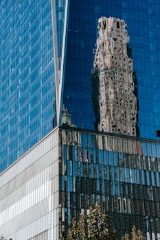 Exterior of contemporary high rise building with glass walls and geometric design in center of city