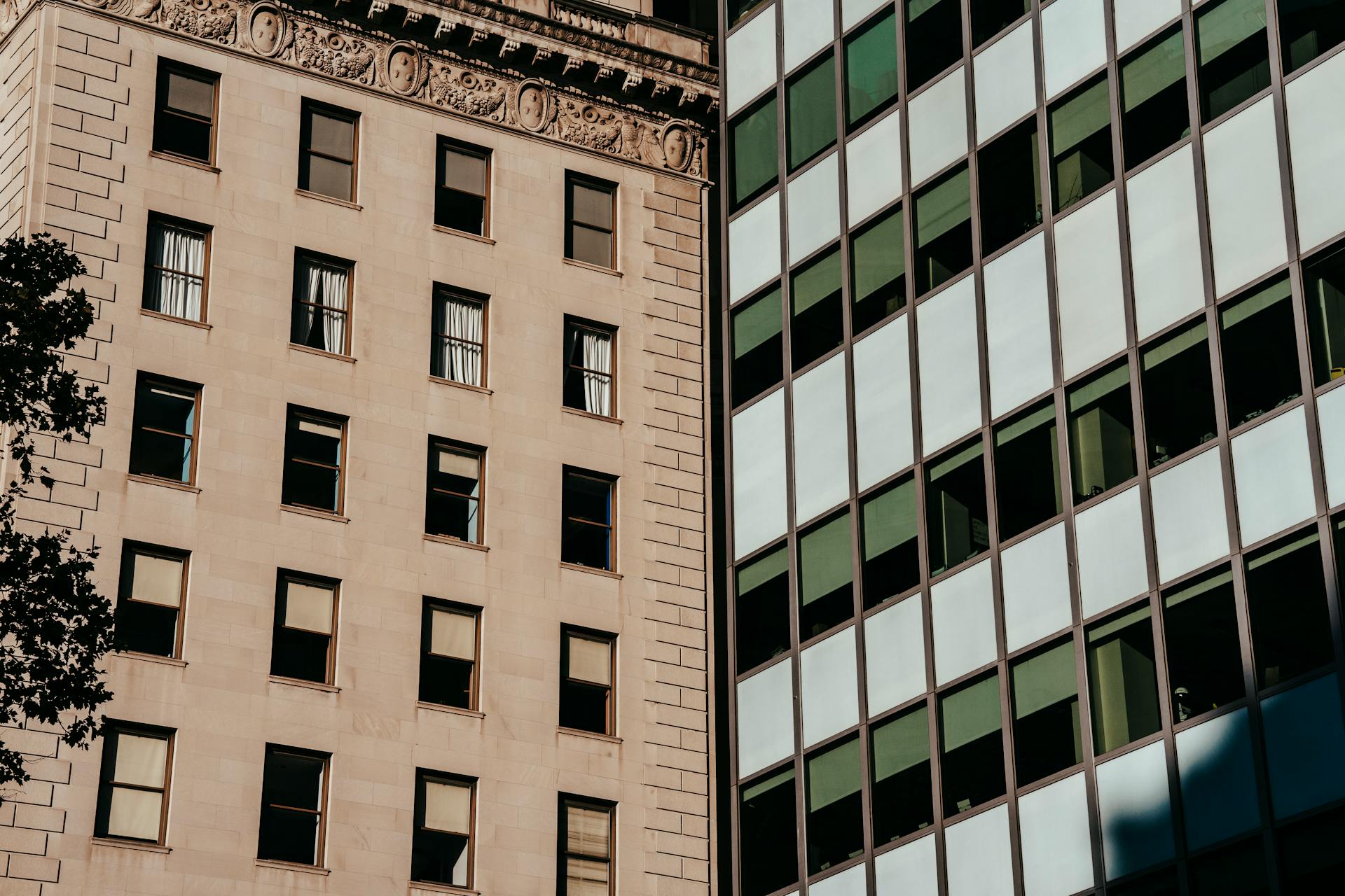 Exterior of stone apartment and glass office buildings located in urban city district in daylight