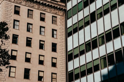 Free Exterior of stone apartment and glass office buildings located in urban city district in daylight Stock Photo