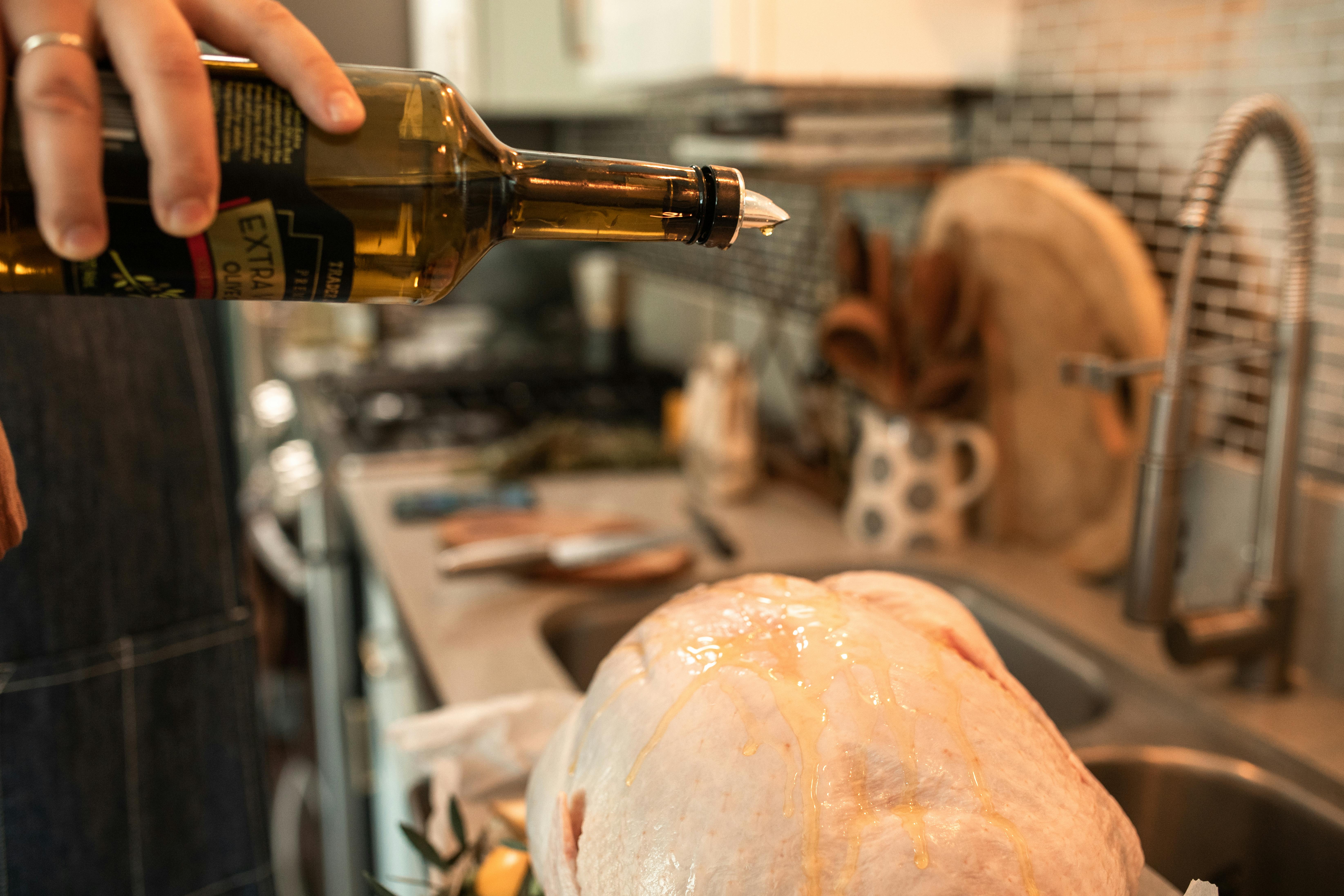 person pouring beer on bottle