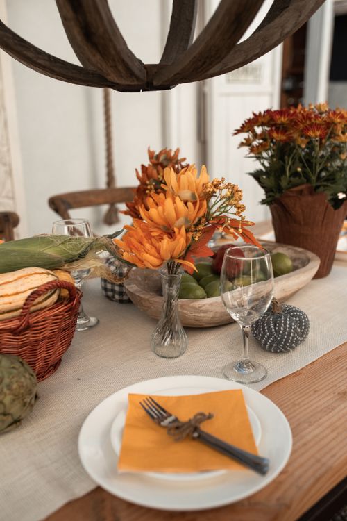 Free A beautifully decorated Thanksgiving table with autumn flowers and tableware, ready for a festive feast. Stock Photo