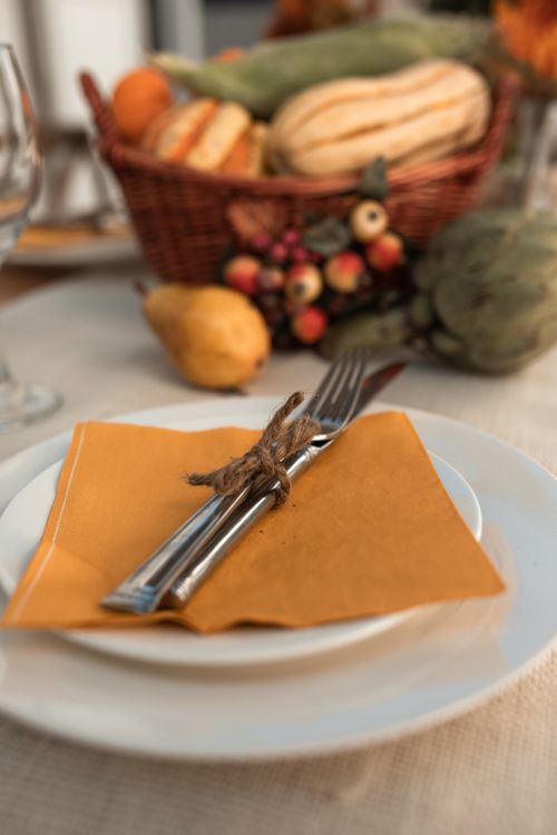 Free Warm and inviting Thanksgiving table setting with autumn decor. Stock Photo