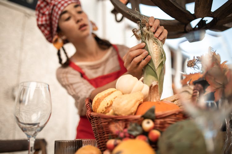 Woman Peeling A Corn