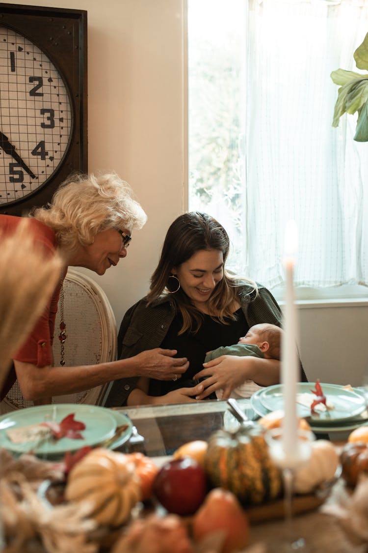 Photo Of Mother Carrying Her Child With Grandmother Showing Fondness