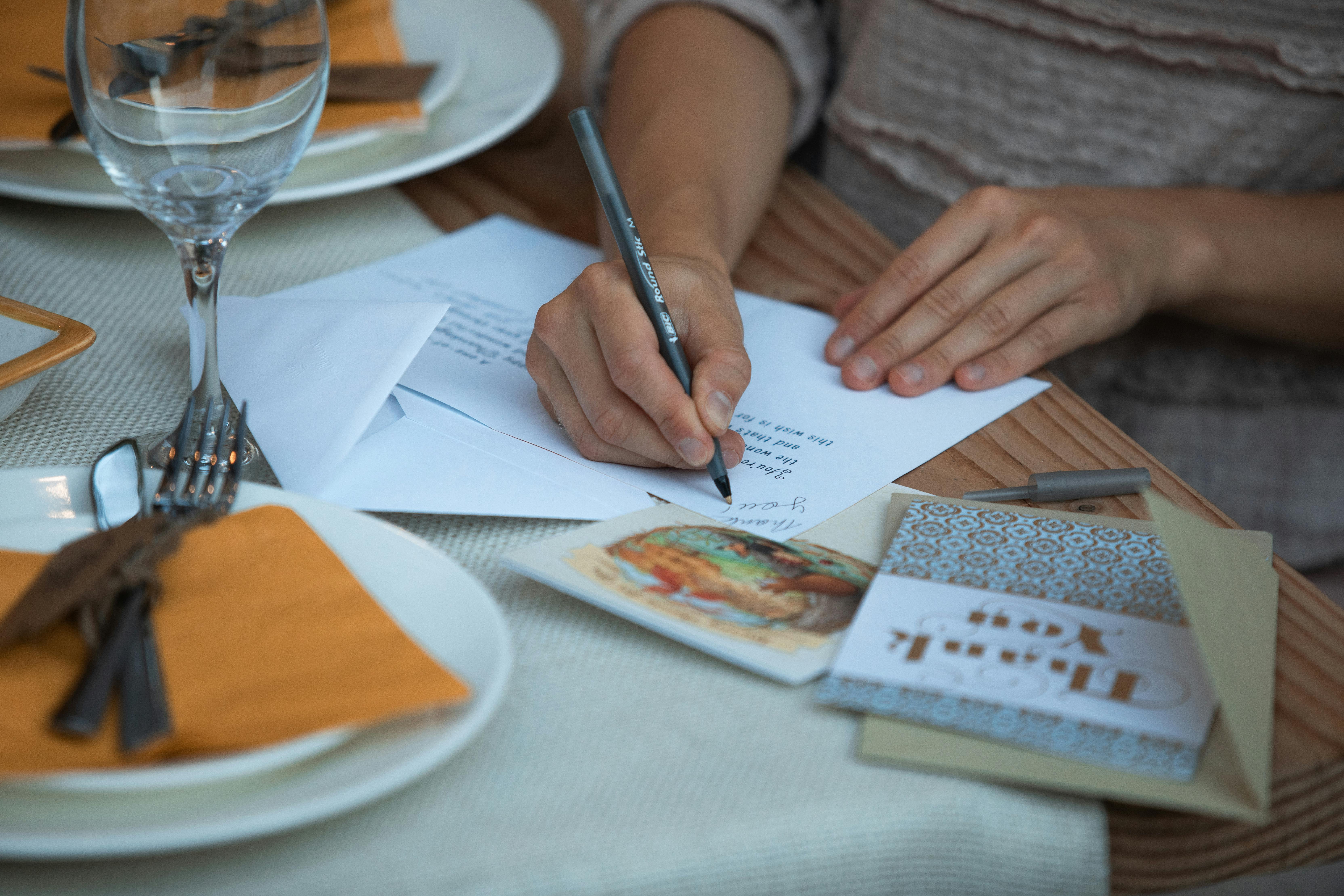 person writing on white paper