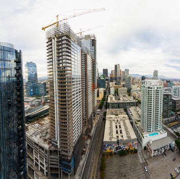 Aerial shot of city skyline featuring skyscrapers and construction in an urban area.