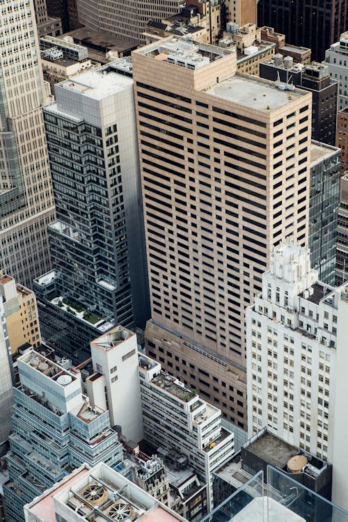 High angle of high rise commerce and residential buildings placed in modern city district in New York in daytime