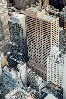 High angle of high rise commerce and residential buildings placed in modern city district in New York in daytime