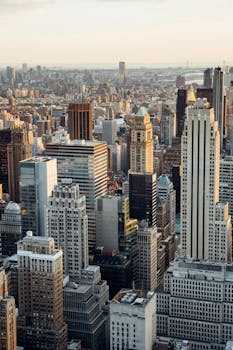 From above of downtown of megapolis with high rise financial and residential buildings located in New York City in daytime
