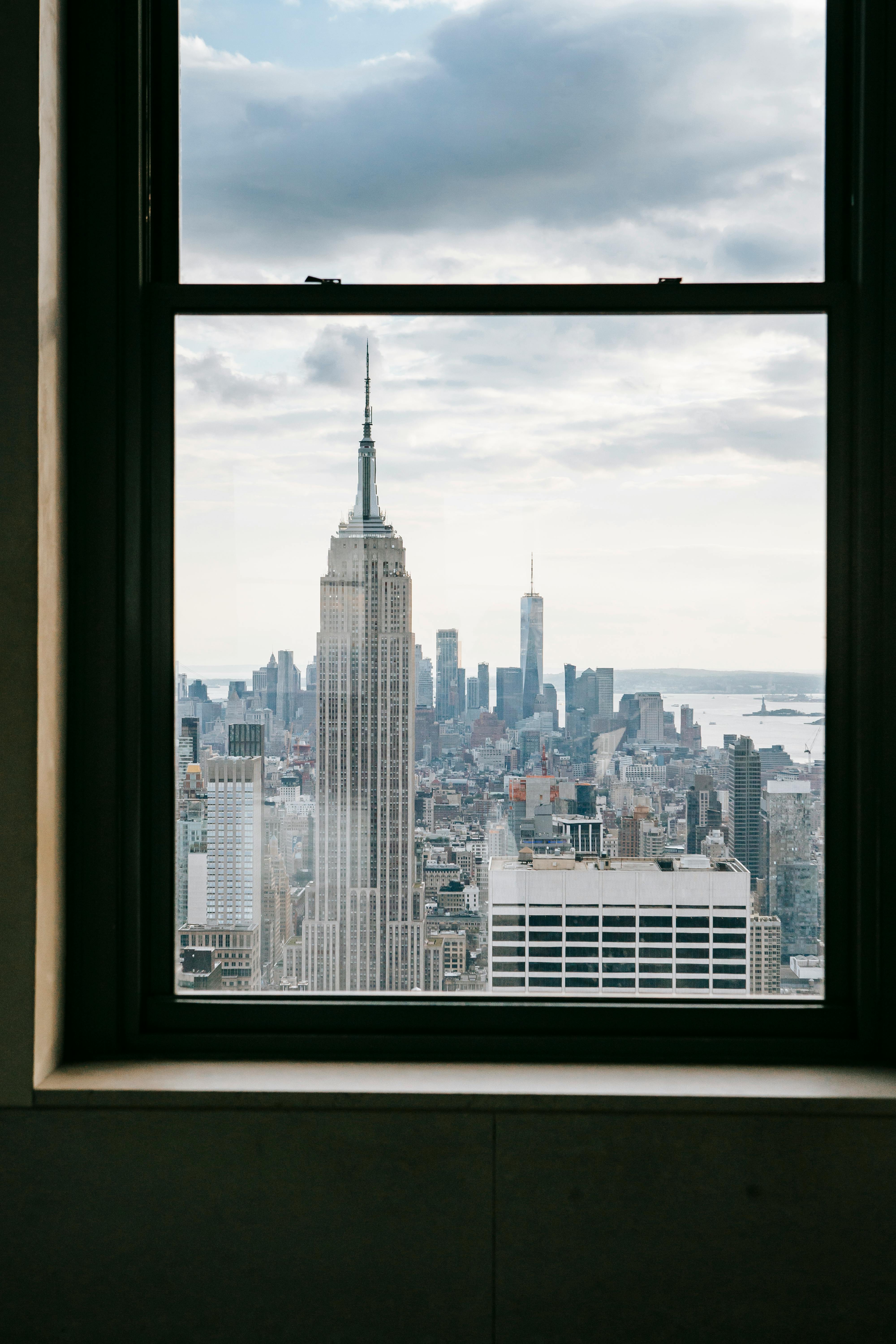 window with view of modern city in daytime