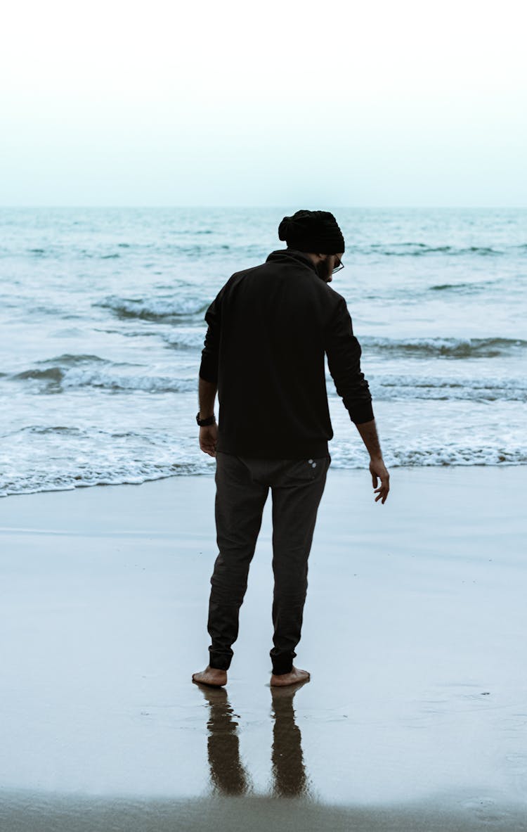 Back Of Man Standing On Beach