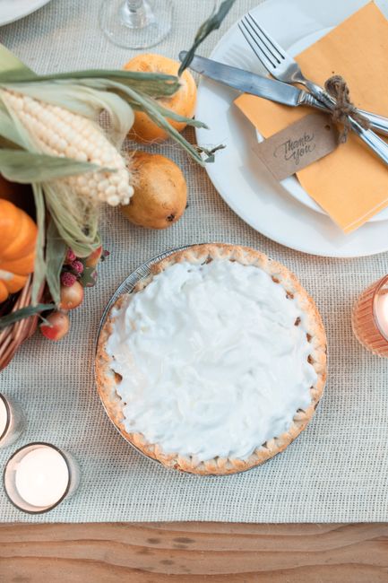 A warm Thanksgiving setting featuring pumpkin pie and decorations for a festive holiday ambiance.