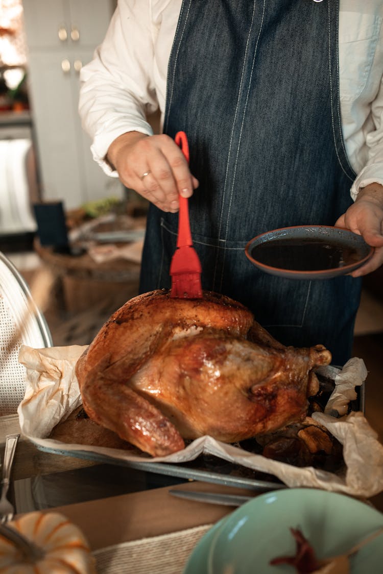 Hand Glazing Chicken With Red Brush