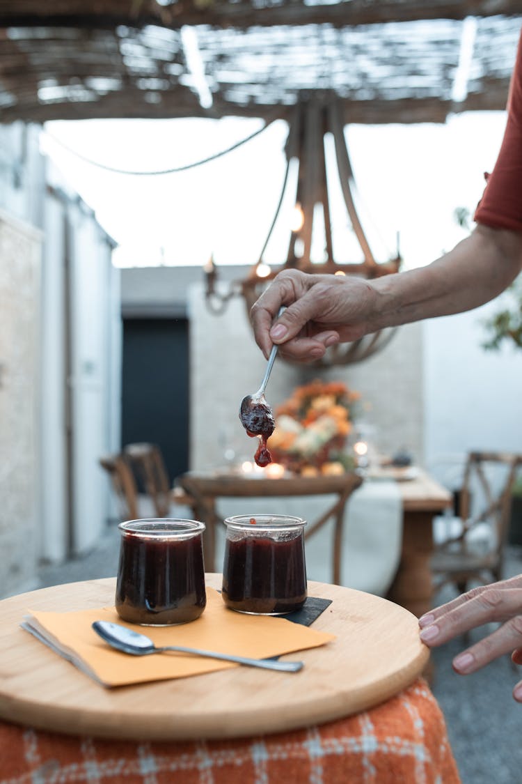 Hand Holding Teaspoon With Pudding