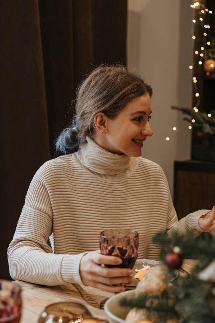 Woman In Beige Turtleneck Shirt Holding Clear Glass 