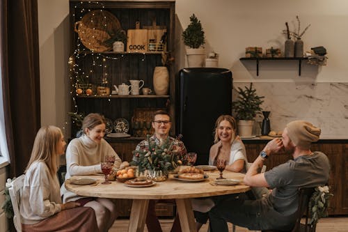 Free People Sitting at the Table Enjoying Conversation Stock Photo