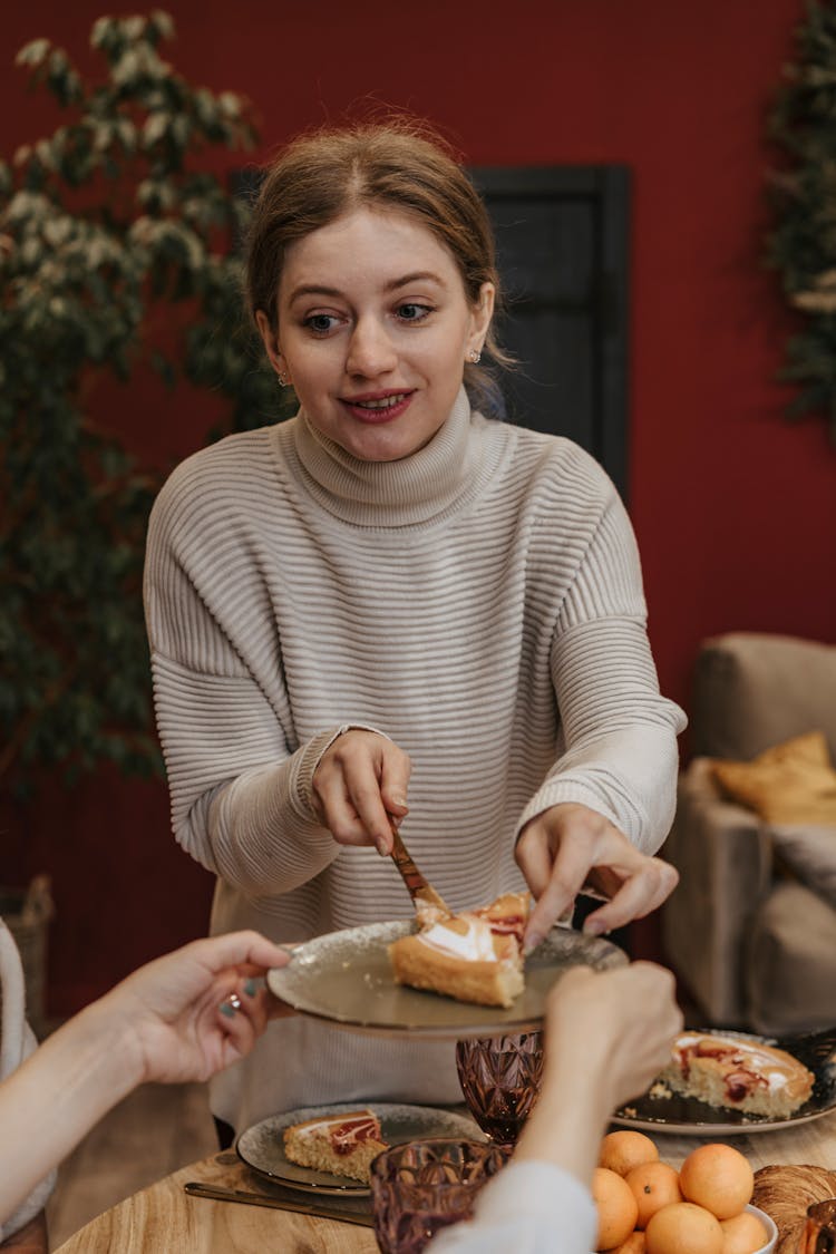 Woman Serving Slice Of Cake