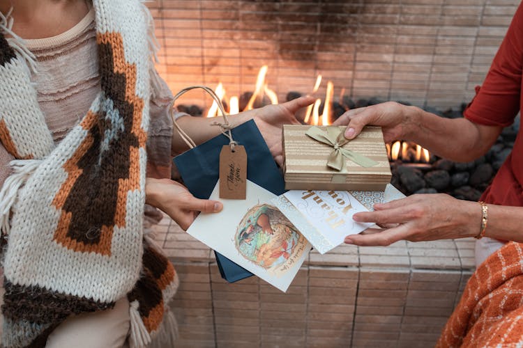 Close-up Shot Of People Exchanging Gifts And Cards