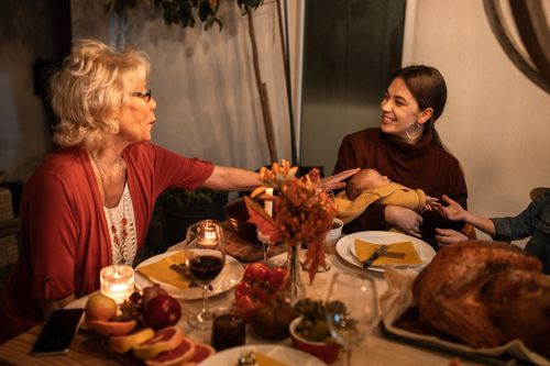 Free A joyful Thanksgiving dinner with family sharing food and laughter around the table. Stock Photo